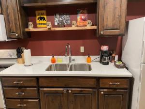 a kitchen with a sink and a refrigerator at Cedar Mountain Suite D in Grants Pass