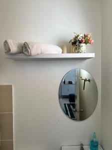 a bathroom with a mirror on a wall at Cosy House in Bacolod City in Bacolod