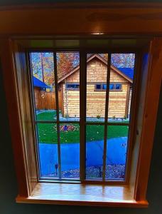 a window in a room with a view of a house at Cedar Mountain Suite E in Grants Pass