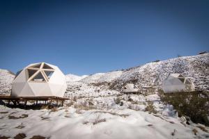 two domes in the snow on a mountain at Domos Andinos HostCamp in Potrerillos