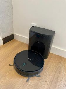 a black computer monitor sitting on a wooden floor at Flores Paradise in Puerto de Sagunto