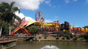 a roller coaster in a amusement park next to a river at Pousada Estrela de Davi in Penha