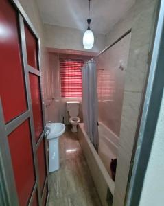 a bathroom with a toilet and a sink and a shower at PALM GROVE APARTMENT in Lagos