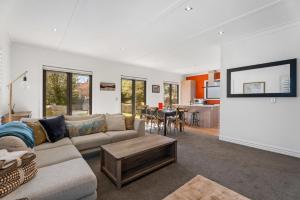 a living room with a couch and a table at Gold Rush Chalet - Cardrona Holiday Home in Cardrona