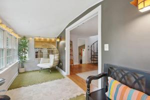 a living room with a white chair in a room at Hot Tub - Fire Pit - Fast Wi-Fi - Pet Friendly - Wine Country Escape in Boyce