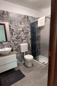 a bathroom with a shower and a toilet and a sink at Family-friendly apartments with swimming pool Pomer, Medulin - 17681 in Pula