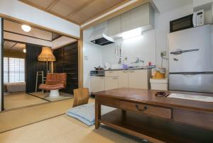 a kitchen with a wooden table and a desk at Kyomachiya Real Kyoto Wabisabi in Kyoto