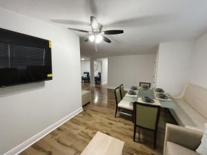 a living room with a table and a ceiling fan at Spacious home in Tampa in Tampa
