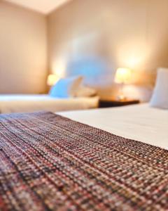 a close up of a bed in a hotel room at Hotel Fio Fio in Puerto Williams