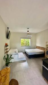 a bedroom with two beds and a window at Área vip maranduba in Ubatuba +65 photos
