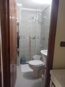 a small bathroom with a toilet and a sink at Imouzzar kandar in Imouzzer du Kandar