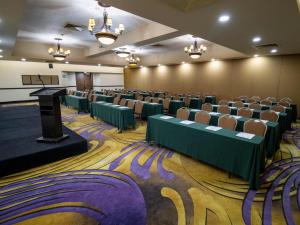 a conference room with rows of chairs and a podium at Hotel Araiza Mexicali in Mexicali +39 photos