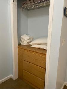 a closet with a wooden dresser and some towels at Seaside bungalow in Daytona Beach