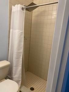 a bathroom with a shower with a toilet at Seaside bungalow in Daytona Beach