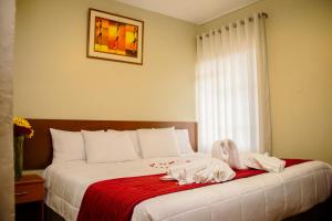 Postel nebo postele na pokoji v ubytování HOSTAL CASA INKAS