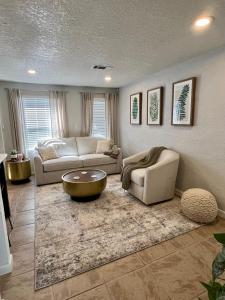a living room with two couches and a coffee table at Beautiful Bungalow in Orlando