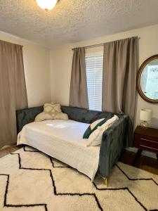 a bedroom with a large bed with a window at Beautiful Bungalow in Orlando