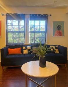 a living room with a blue couch and a table at Gorgeous 2bed in Century City in Los Angeles