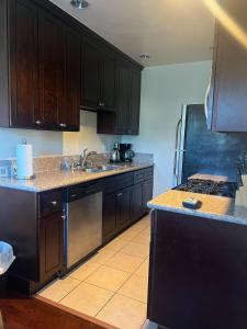 a kitchen with black cabinets and a stove top oven at Gorgeous 2bed in Century City in Los Angeles