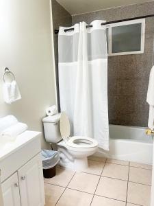 a white bathroom with a toilet and a shower at Gorgeous 2bed in Century City in Los Angeles