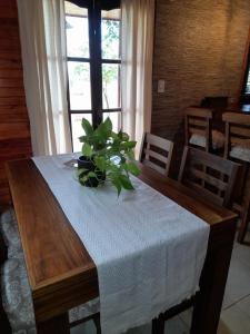 a table with a white table cloth and a plant on it at Cabañas Edna in Tinogasta