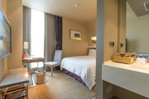 a hotel room with a bed and a bathroom at Shanghai Hongqiao Airport Hotel - Air China in Shanghai +37 photos