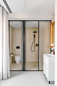 a bathroom with a glass shower with a toilet at Central Club Hotel - North Melbourne in Melbourne