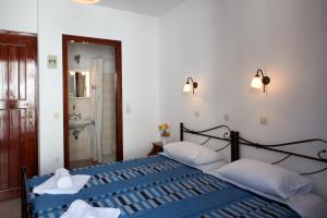 a bedroom with two beds with towels on them at Hotel Kyma in Skala Eresou