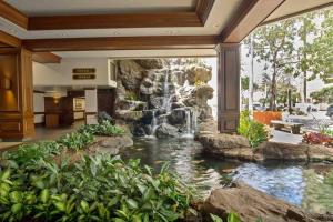 a waterfall in the lobby of a hotel at Hawaii Nei Charming 1 bedroom VIEWS Sleeps 4 in Honolulu