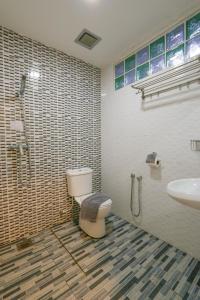 a bathroom with a toilet and a sink at Travelland Hotel in Ipoh