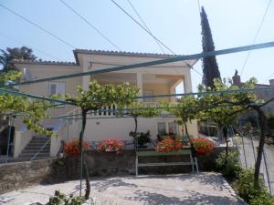 a house with trees in front of it at Apartment Kiki Candy in Malinska