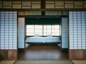 Letto o letti in una camera di NIPPONIA Chichibu Monzenmachi