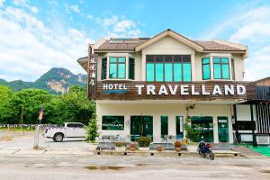 a hotel with a truck parked in front of a building at Travelland Hotel in Ipoh