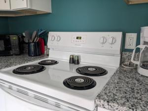 a white stove top oven in a kitchen at Robin's Nest 2br At Duke Regional in Durham