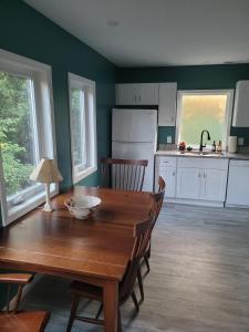 a kitchen with a wooden table and a dining room at Robin's Nest 2br At Duke Regional in Durham