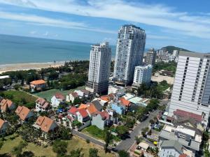 an aerial view of a city with buildings and the ocean at CONDOTEL THE SÓNG AN GIA VŨNG TÀU APARTMENT MrVƯƠNG in Vung Tau