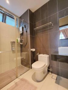 a bathroom with a toilet and a glass shower at D'Secret Tropika - 2 Bedrooms 4 Pax, Free Parking in Johor Bahru +24 photos