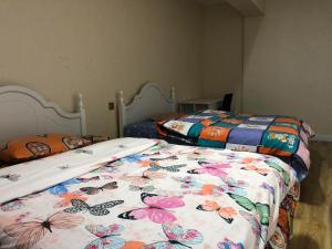 two beds in a room with two beds with butterflies at Eagle Town Serviced Apartment- Free Pick up from Airport in Ulaanbaatar
