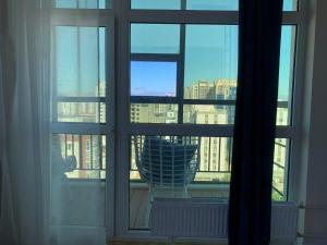 a window with a view of a city skyline at Eagle Town Serviced Apartment- Free Pick up from Airport in Ulaanbaatar