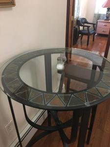 a glass table with a glass top on a table at A private humble abode in Brooklyn