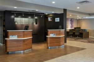 a lobby with two counters and a desk at Courtyard by Marriott Lincroft Red Bank in Red Bank