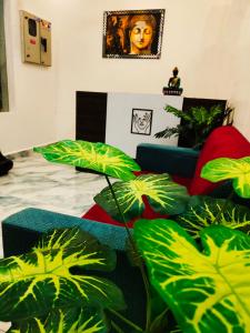 a living room with green plants and a couch at DE LUMA Beach View in Puducherry