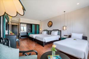 Postel nebo postele na pokoji v ubytování Hadana Boutique Resort Hoi An