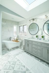 a white bathroom with a tub and a sink at 2-Acre Highland Park Retreat with Heated Pool ~ 5* in Highland Park