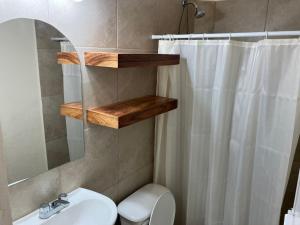 a bathroom with a sink and a toilet and a shower at Los Amores Apartments A in Pérula