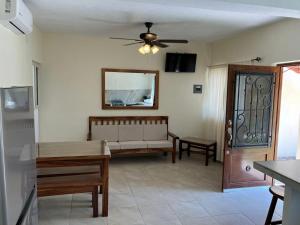 a living room with a couch and a ceiling fan at Los Amores Apartments B in Pérula