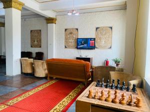 a living room with a chess board on a table at Songino budget resort in Songiin