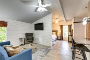 a living room with a blue couch and a tv at Atlanta Vacation Rental 9 Mi to Downtown! in Atlanta