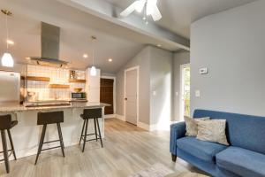 a living room with a blue couch and a kitchen at Atlanta Vacation Rental 9 Mi to Downtown! in Atlanta