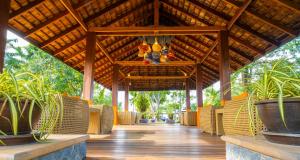 a pavilion with chairs and plants on a wooden floor at Bandara Spa Resort & Pool Villas, Samui in Bophut